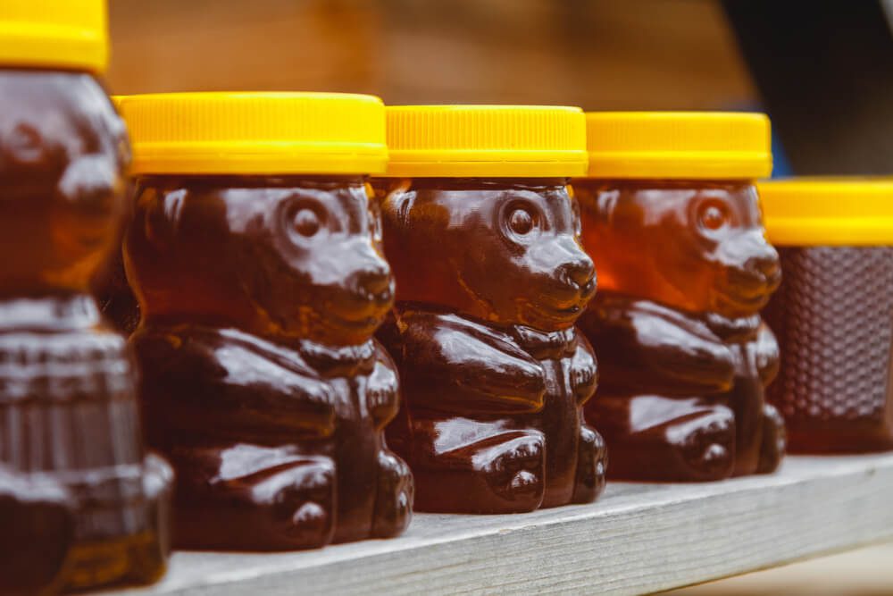 Honey bears sit on a vendor's table at the Tupelo Honey Festival.
