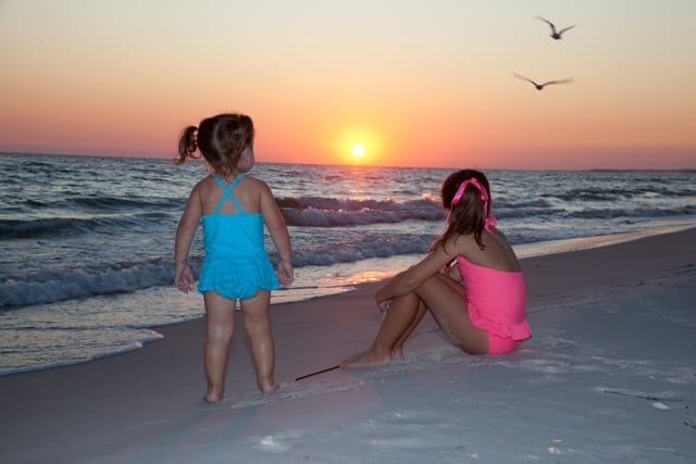 Two girls watching a sunset.