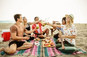 A group of friends enjoy a picnic on the beach on the Florida Gulf Coast.