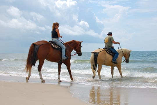 Horseback riding on the beach.
